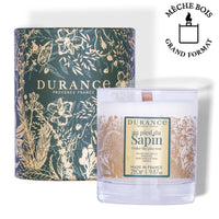 Bougie mèche bois au pied du sapin